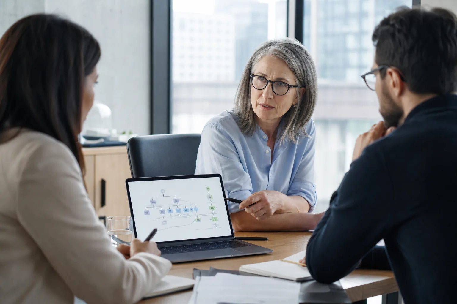 Focused AI consulting meeting where a workflow diagram reveals hidden assumptions